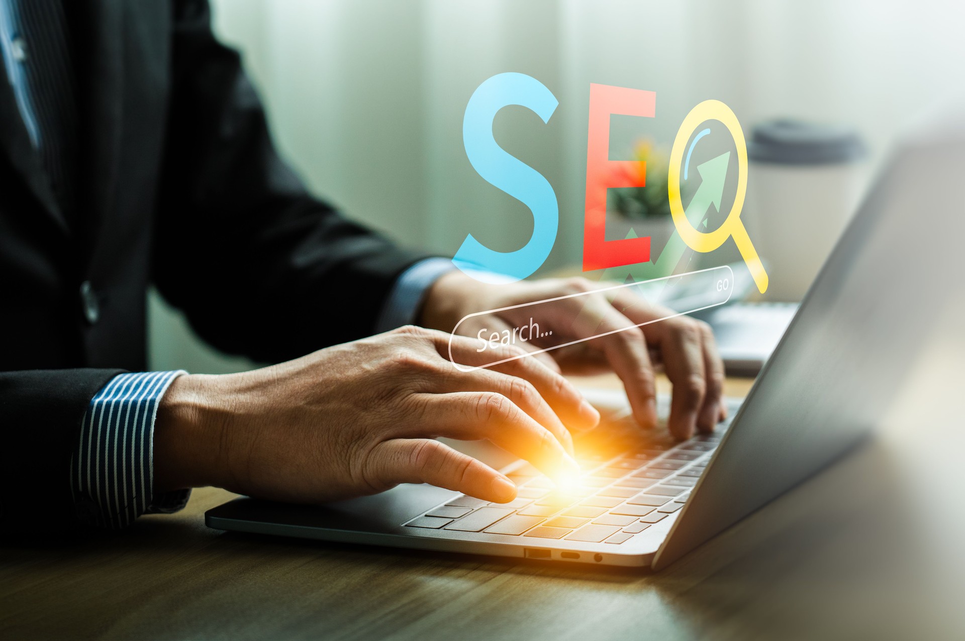 Professional working on SEO optimization with a laptop, utilizing a search engine interface and digital tools for boosting website traffic and improving online visibility in a modern workspace.